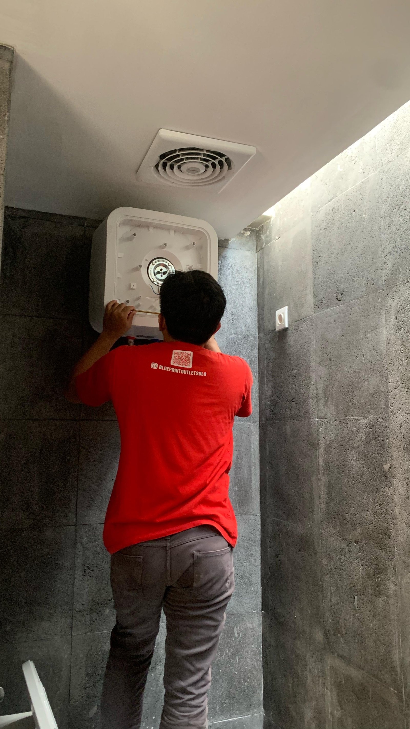 Technician Working on Water Heater